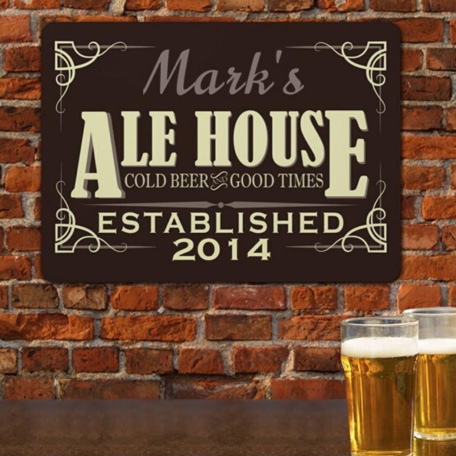 Custom Alehouse Sign - personalized hung on a brick wall with beer in foreground