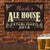 Custom Alehouse Sign - personalized hung on a brick wall with beer in foreground