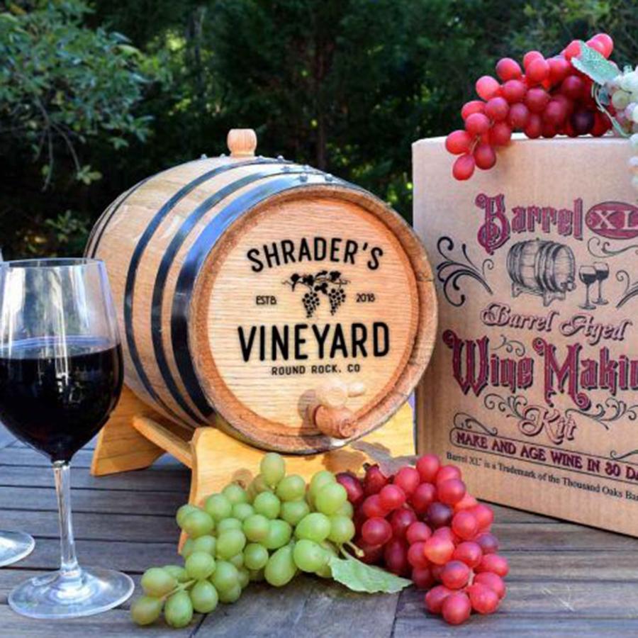 Custom Barrel XL® Cabernet Wine Making Kit - Vineyard design - - displayed with box, grapes and wine on table outdoors