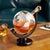 Etched World Continents Decanter displayed on table with whiskey inside and whiskey glass in background