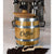 Javanator® Barrel Aged Coffee Infuser barrel Infront of espresso machine on a white counter. Coffee beans are laid in the foreground